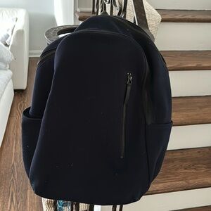 Everlane navy blue cotton backpack and black leather strap
